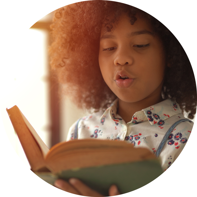 Young African girl reading a book